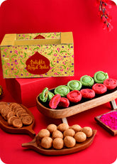 A colorful assortment of Indian sweets including Pista & Rose Chandrakala, Kachori, and Bhakarwadi, and Herbal Gulal on this pack.