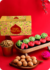 Holi gift pack for festive celebrations including rose chandrakala, pista chandrakala, kachori, pudhina paree and herbal gulal.