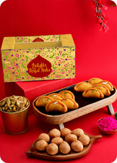 A Holi gift pack containing Shahi Gujiya, Pudhina Paare, Kachori and herbal gulal.