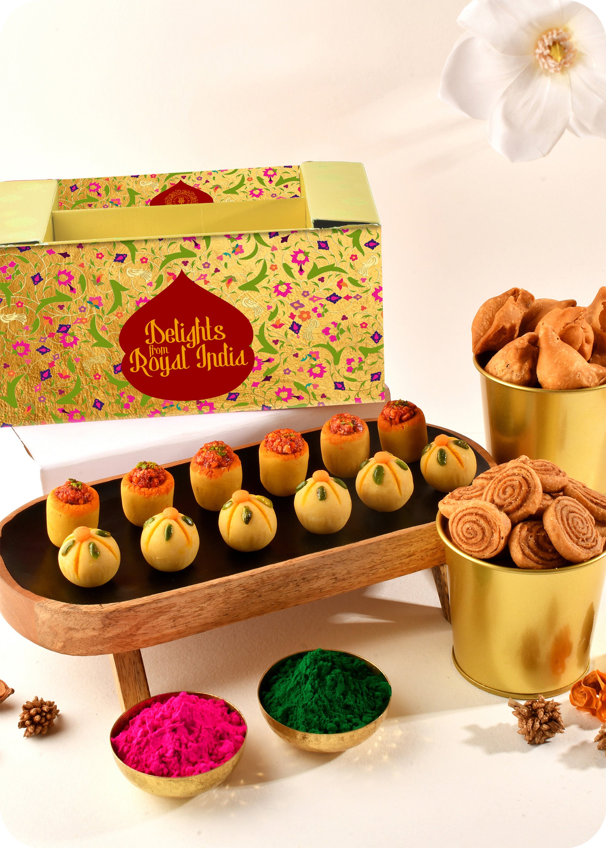 Holi sweets including Thandai Laddoo, Pan Laddoo, Samosa, and Bhakarwadi, and herbal gulal.