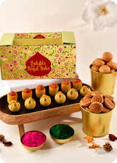 A colorful presentation of Holi sweets including Thandai Laddoo, Pan Laddoo, Kachori, and Bhakarwadi, and herbal gulal.