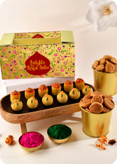 Holi gift pack for festive celebrations thandai ladoo, pan ladoo, methi sawli, bhakrwadi and herbal gulal.
