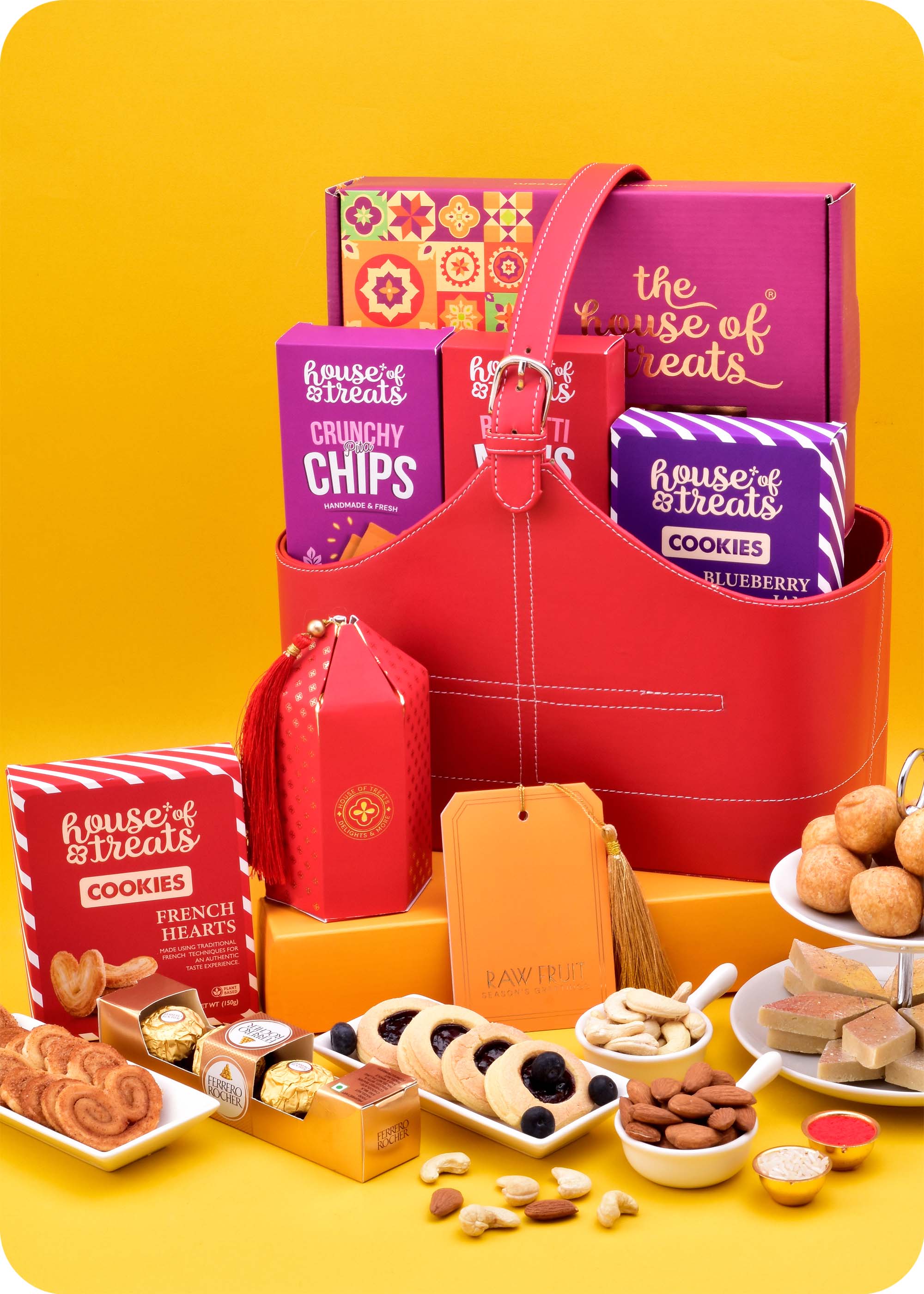 Gift Hamper: Snacks, Cookies with Sweets including kaju katli, samosa, pita chips, pizza mini, blueberry jam cookies, french hearts cokkies, ferrero rocher chocolate pack of 4 and cashews, almonds