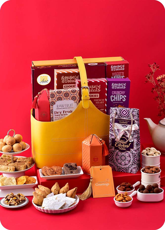 Gourmet Indulgence: Sweets with Assorted Savories Hamper including kaju katli, milk cake, samosa, kachori, french heart cookies, belgian chocochip cookies, pizza mini, pita chips, dry fruit nutty brittle, chocolates, cashews, almonds