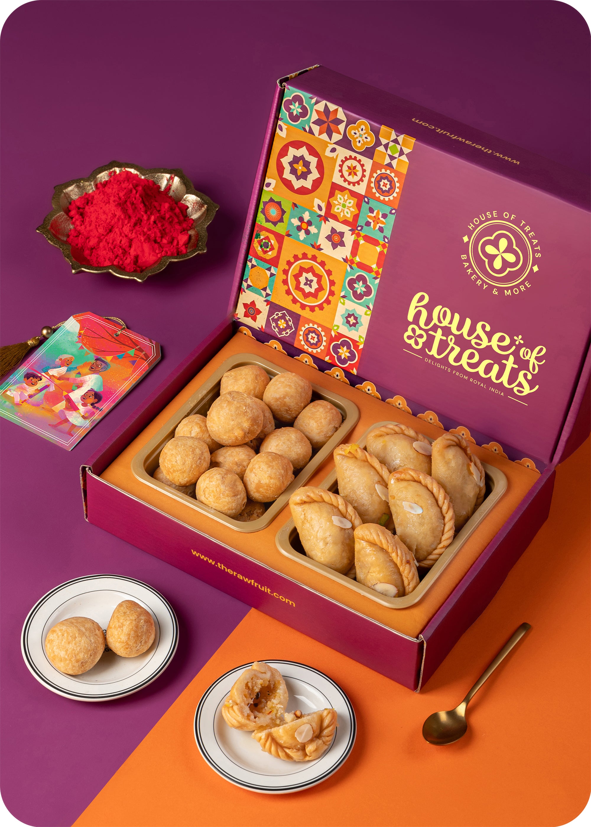 A colorful box of Holi sweets including gujiya, kachori, and herbal gulal.