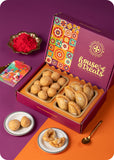 A colorful box of Holi sweets including gujiya, kachori, and herbal gulal.