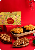 A colorful Holi gift pack consisting of sweets including gujiya, bhakarwadi, kachori and herbal gulal.