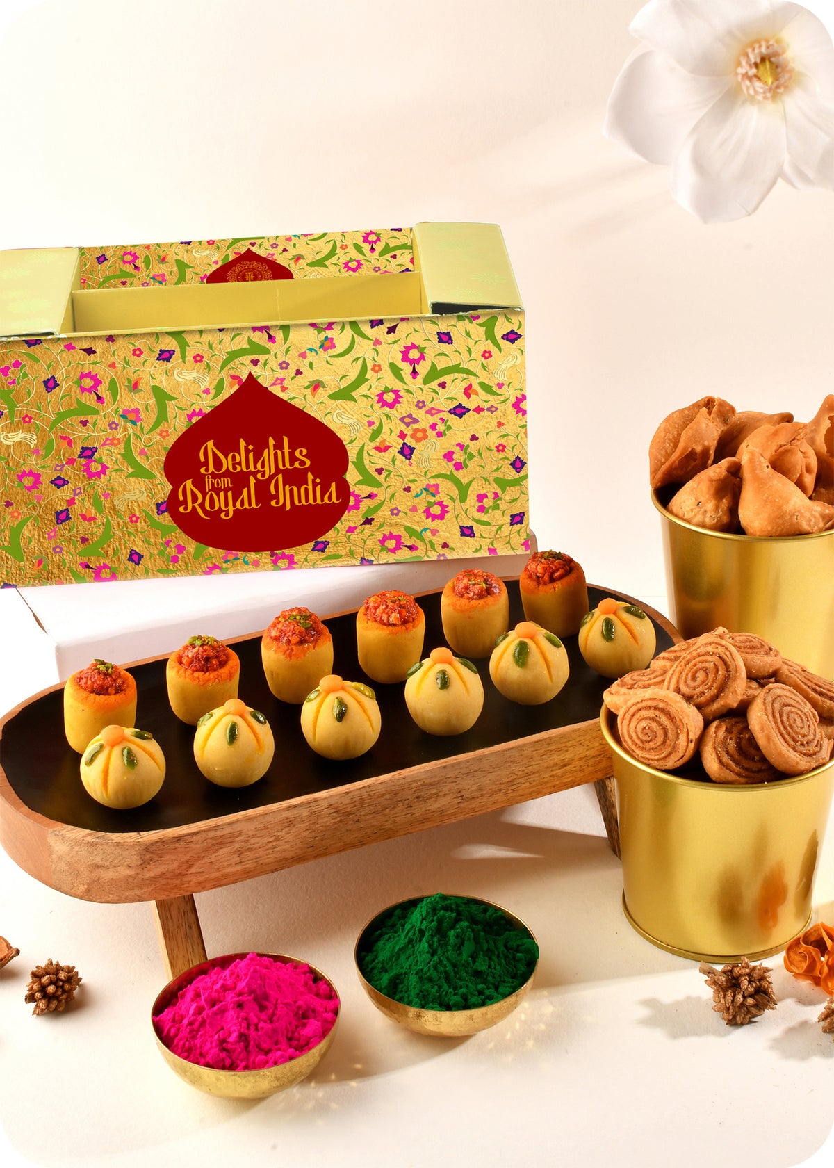 Holi sweets including Thandai Laddoo, Pan Laddoo, Samosa, and Bhakarwadi, and herbal gulal.