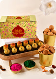 A colorful presentation of Holi sweets including Thandai Laddoo, Pan Laddoo, Kachori, and Bhakarwadi, and herbal gulal.