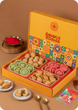 A colorful Holi Gift Pack from The House Of Treats containing various traditional Indian snacks such as Pista & Rose Chandrakala, Samosa, and Kachori and herbal gulal.